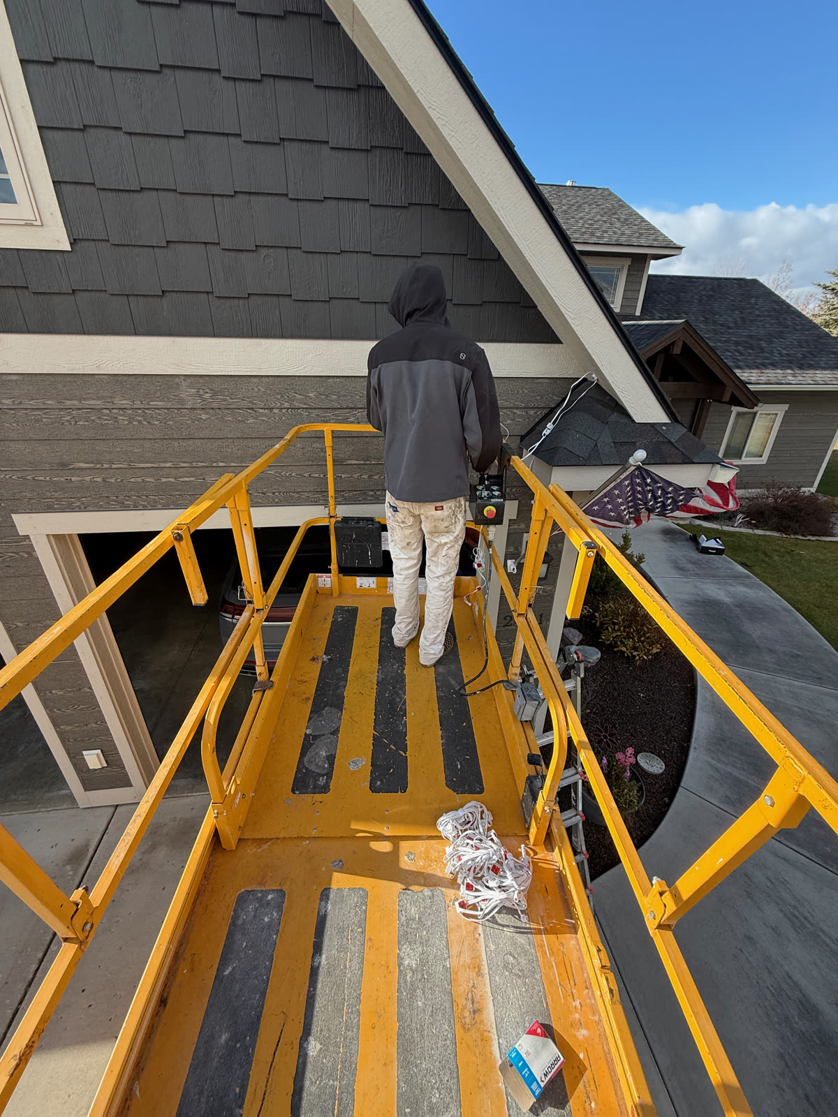 Working the roofline from the lift platform by Montana Lights
